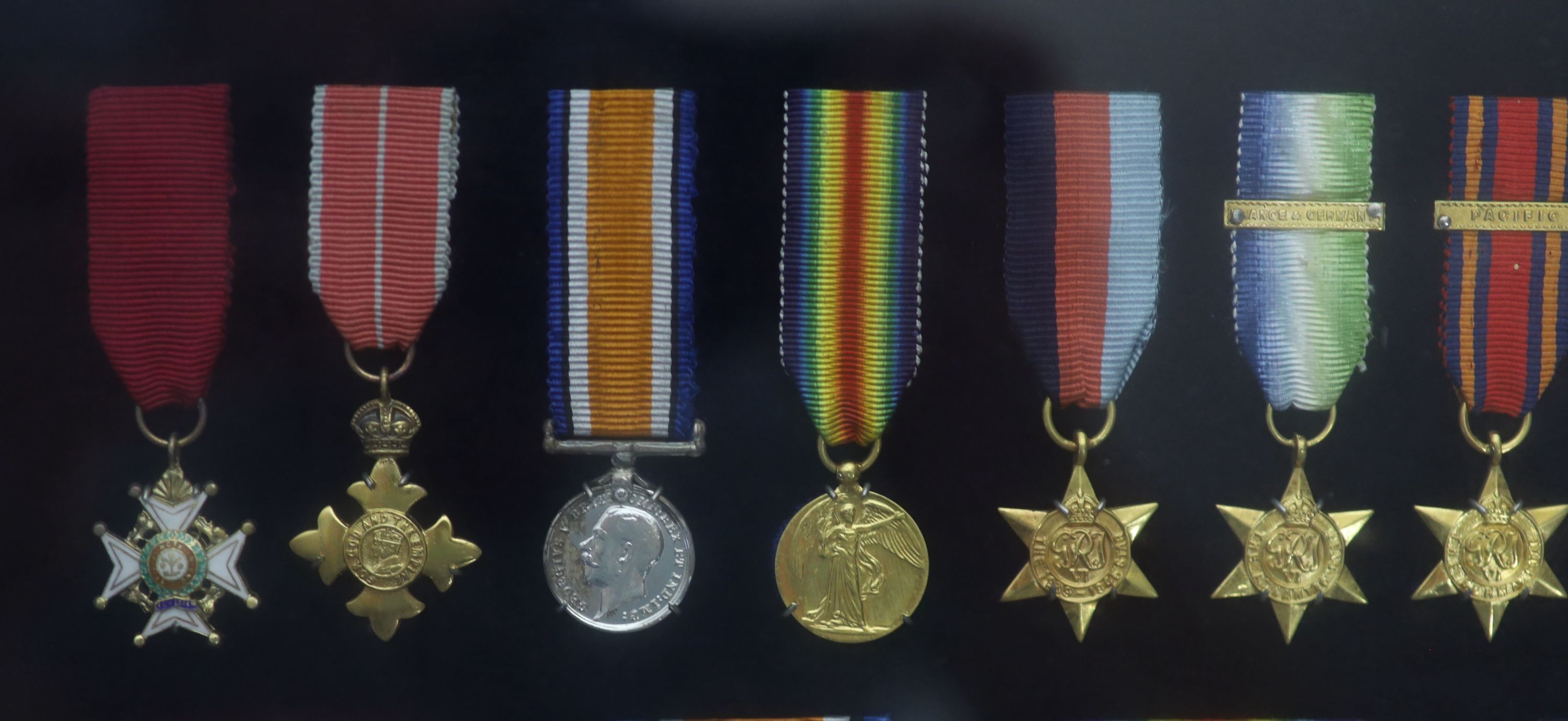 A cased WWI, WWII and Military C.B. medal group to Rear-Admiral John Dent R.N. (1899-1973) and a cased KCVO and Order of St. John to his son Sir Robin John Dent (1929-1999) Case 45.5 x 36 cm